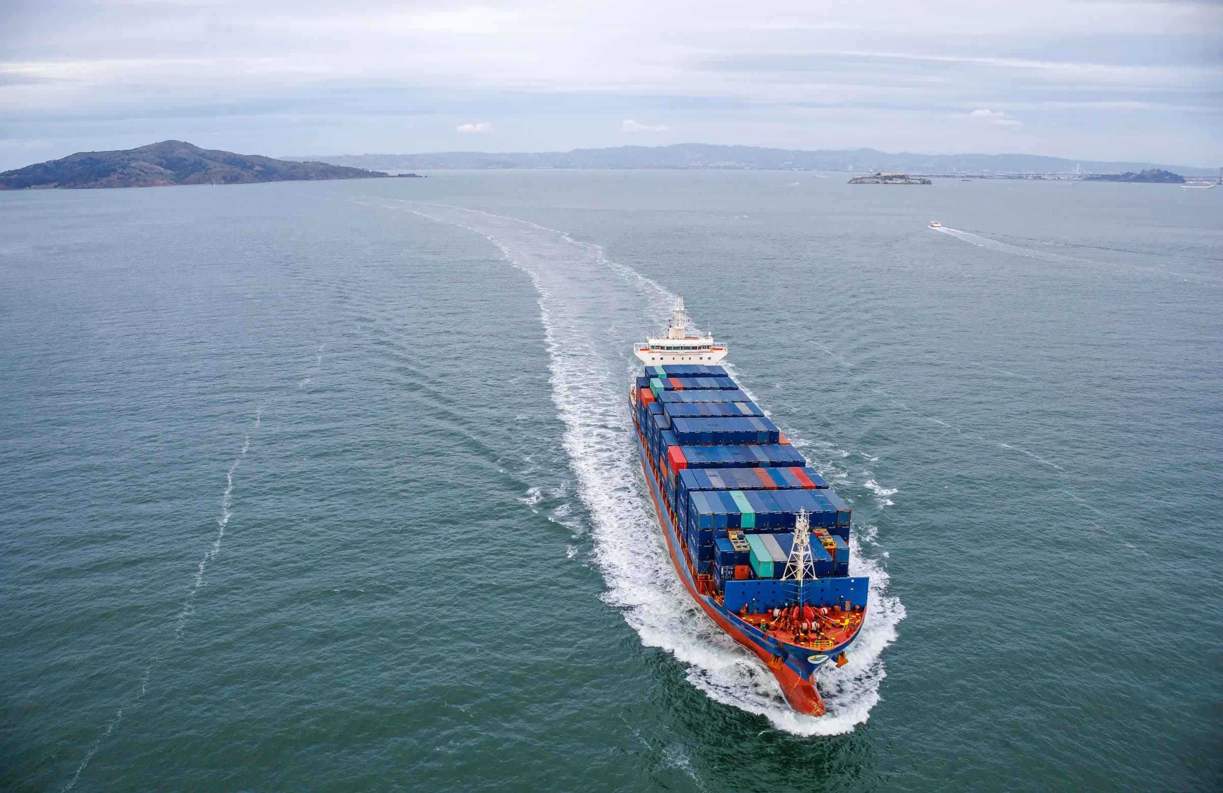 Loaded container ship sailing across open water